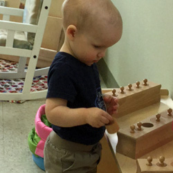 boy with Montessori learning tools