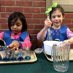 two girls pouring liquids