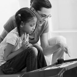 teacher with girl painting