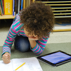 child with notebook and tablet