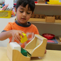 boy with Montessori teaching tool