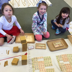 group of girls with Montessori learning tools